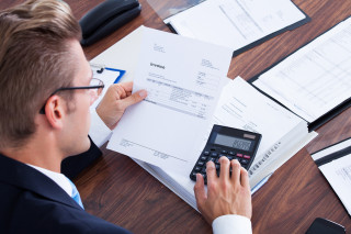 Businessman Using Calculator