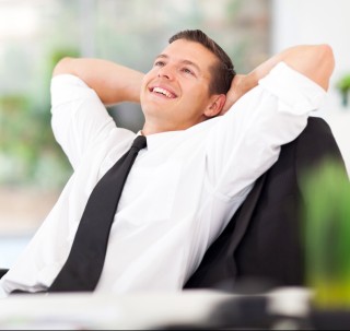 handsome businessman daydreaming in his office